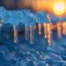 Close-up of icicles with a warm sunset in the background. - Gelo record, il meteo che potrebbe superare ogni previsione