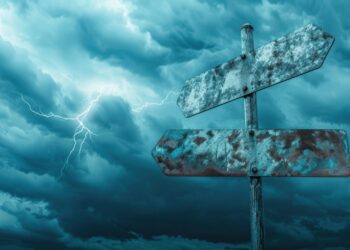 Metallic empty blank crossroad signpost mockup against blue sky and clouds - Meteo: confermati nubifragi, le regioni a rischio