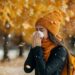 In a park in autumn, a woman sneezes and blows her nose in a handkerchief - Meteo Italia: continua la fase instabile con altre piogge e temporali