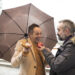 couple of executives offer each other apple on the street in the rain in winter - Meteo Italia: seconda perturbazione intensa con temporali e neve a bassa quota!