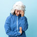 Young Uruguayan girl with winter hat isolated on blue background laughing - Meteo weekend: sabato soleggiato e freddo notturno, poi arriveranno cambiamenti