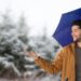 Digital composite of Man with blue umbrella in snow forest - Meteo: calore subtropicale a fine mese, l’estate persiste