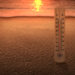 Thermometer measuring the temperature on the beach with a sunset - Meteo: ritorno del caldo, mezza Italia si toglie i cappotti