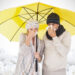 Couple sneezing in tissue while standing under umbrella against white background with vignette - Previsioni meteo prossime settimane: abbondante neve, ecco le zone interessate