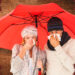 Ill couple sneezing in tissue while standing under umbrella against overhead of wooden planks - Previsioni meteo: neve insolita in pianura prevista per il Nord Italia