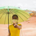 a young beautiful african lady wearing face mask prevent, preventing, prevented herself from the outbreak in the society and points at her face mask - Meteo, neve pesante e rara: l’inaspettata sorpresa dell’ultima ora