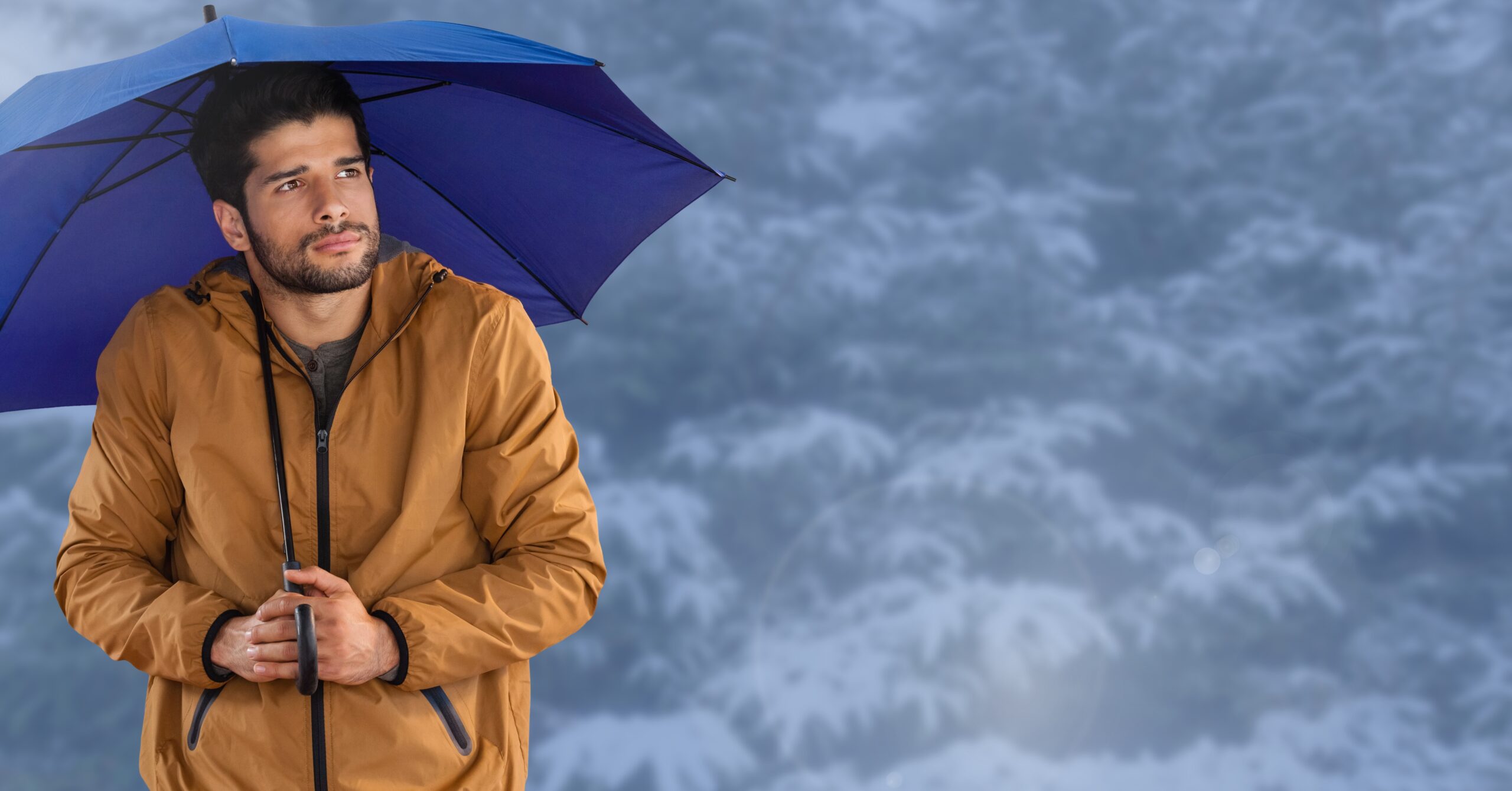 Digital composite of Man with blue umbrella in blue snow forest - Previsioni meteo: weekend ancora instabile e freddo, ma attenzione