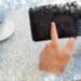 Businessman using small tablet at table against snow - Meteo: da un ciclone all’altro, dicembre è già turbolento